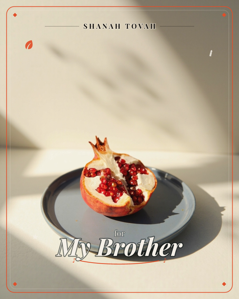 A halved pomegranate sits on a slate-blue plate, its ruby seeds catching a shaft of afternoon sun that also throws leafy shadow shapes across the pale…, a rosh hashanah e-card design