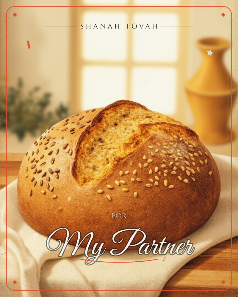 A round loaf of seeded bread sits on a linen cloth beside a sunlit window, its golden crust cracked open to show the soft crumb inside, a rosh hashanah e-card design
