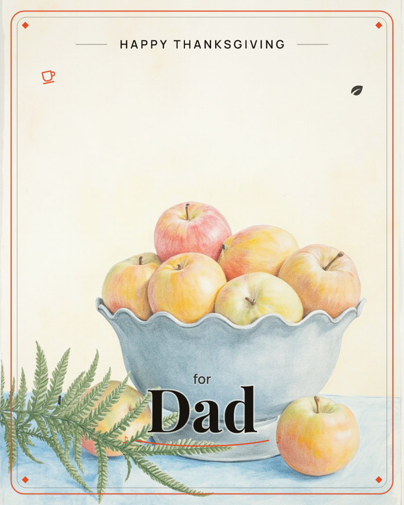 A scalloped-edge grey bowl sits piled high with rosy yellow-and-red apples, one fallen loose beside a trailing fern frond on a pale blue tabletop, a thanksgiving e-card design