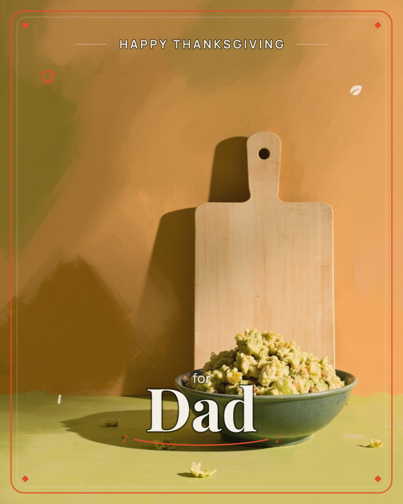 A wooden paddle-shaped chopping board leans against a warm ochre wall, casting a long dramatic shadow, with a dark green bowl of pale, curdy grated…, a thanksgiving e-card design