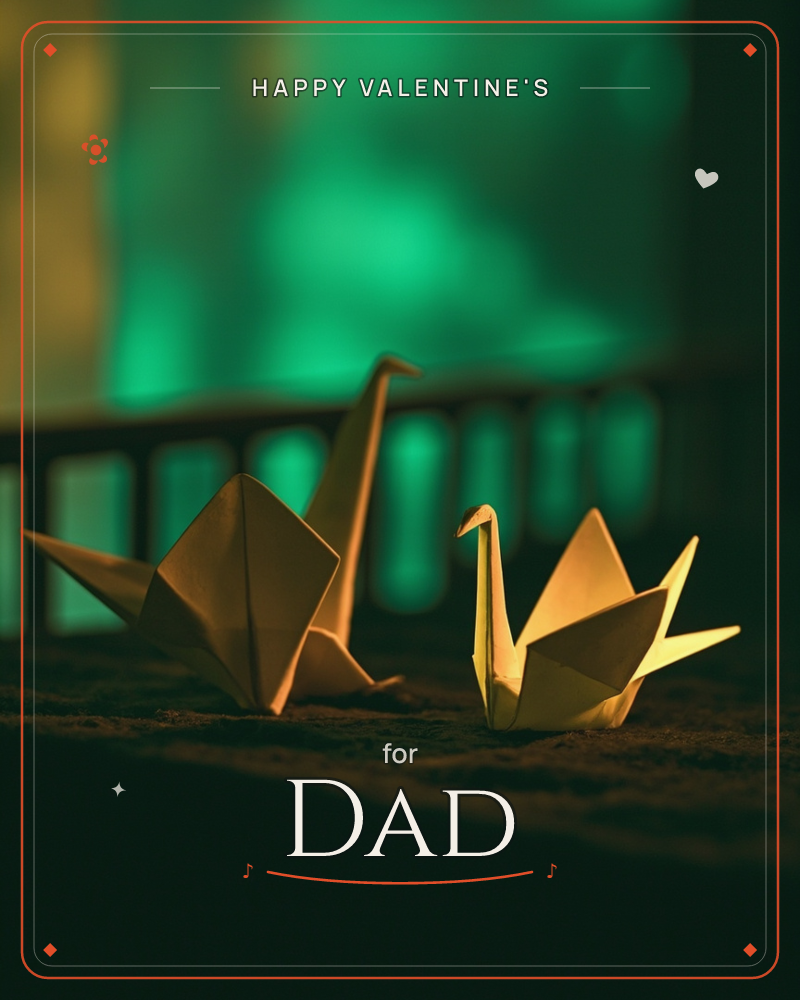 Two golden origami cranes sit on a dark surface, lit warmly from the side against a dreamy emerald-green bokeh backdrop with a faint fence-like silhouette, a valentine e-card design