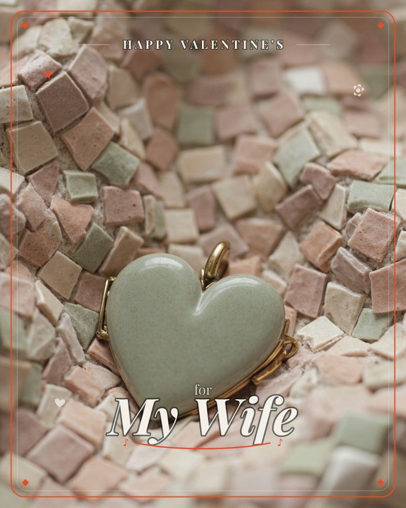 A pale sage-green ceramic heart pendant, edged in gold, rests atop a mosaic of tiny square tiles in dusty pink, cream and soft green, a valentine e-card design