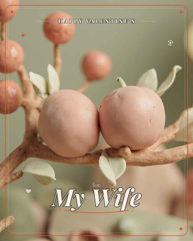 A close-up of an artificial branch holding two round, peach-toned berries nestled side by side, surrounded by smaller mauve buds and pale, papery leaves, a valentine e-card design