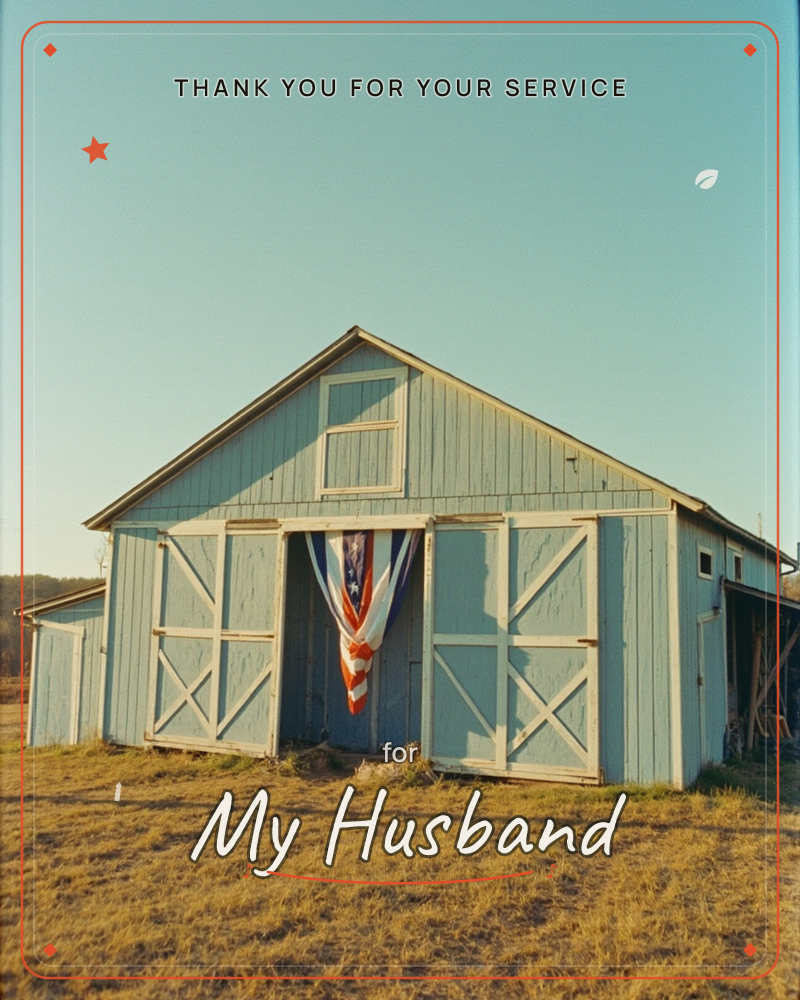 A weathered pale-blue barn stands alone in an open field, its white cross-braced doors slightly parted to reveal a red, white and blue flag hanging inside, a veterans day e-card design