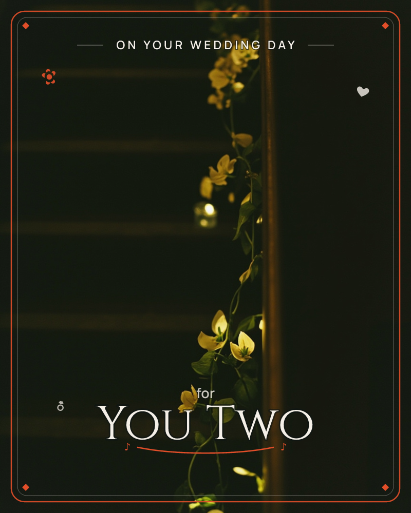 A darkened staircase glows softly where a garland of small string lights and green vines with pale yellow flowers trails down the banister, a wedding e-card design